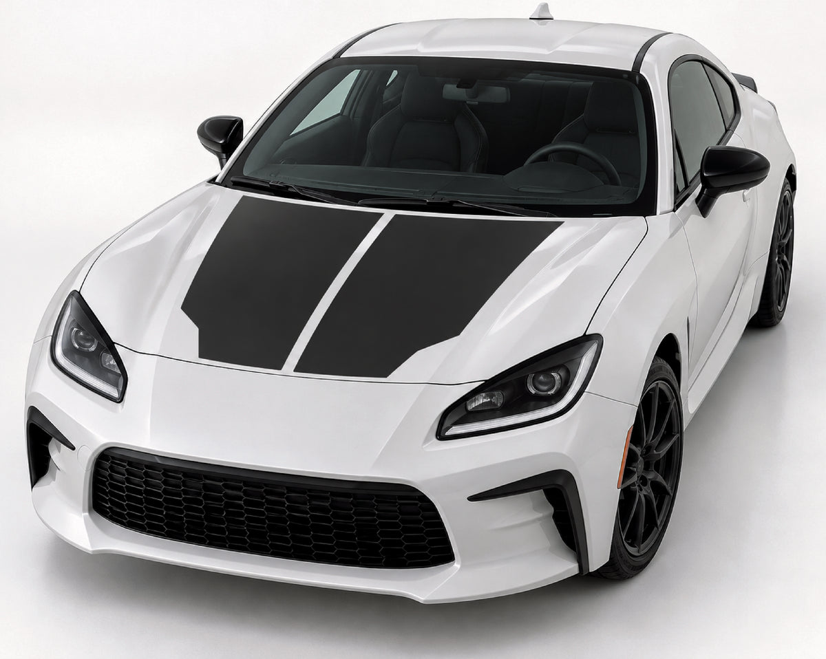 A white sports coupe with bold black racing stripes on the hood, shown from a three-quarter front angle on a clean light gray studio background.