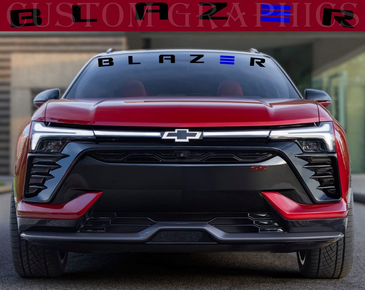 A red Chevrolet Blazer vehicle with a custom die-cut decal on the front window, showcasing the brand logo and 'Blazer' text.
