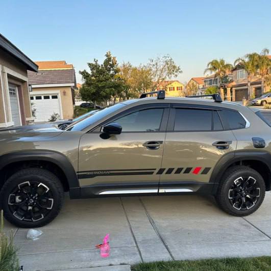 A Mazda CX-50 vehicle with vinyl stripes and decals applied to its body, showcasing a custom styling addition.