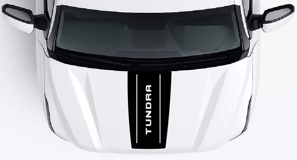 Close-up of a Toyota Tundra vehicle grille with 'Tundra' branding.