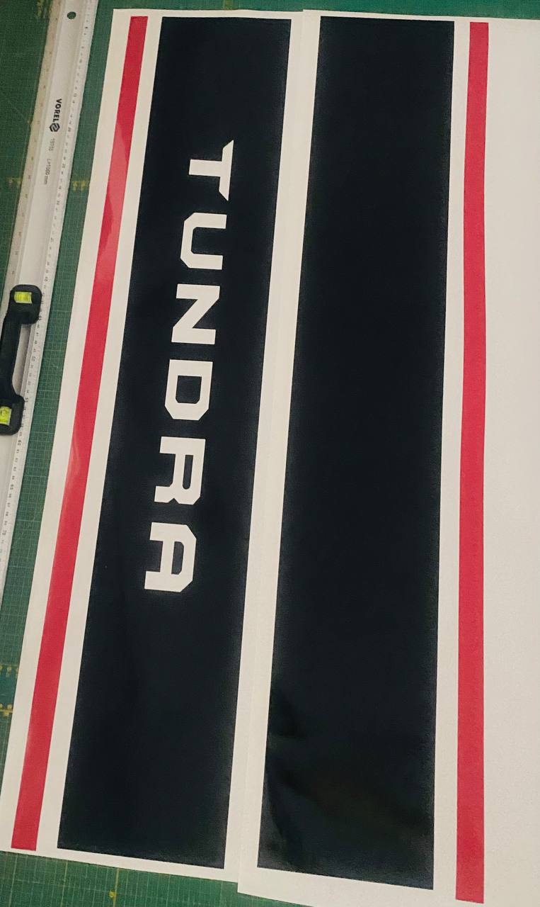 Tundra decal with red and white stripes on a black background