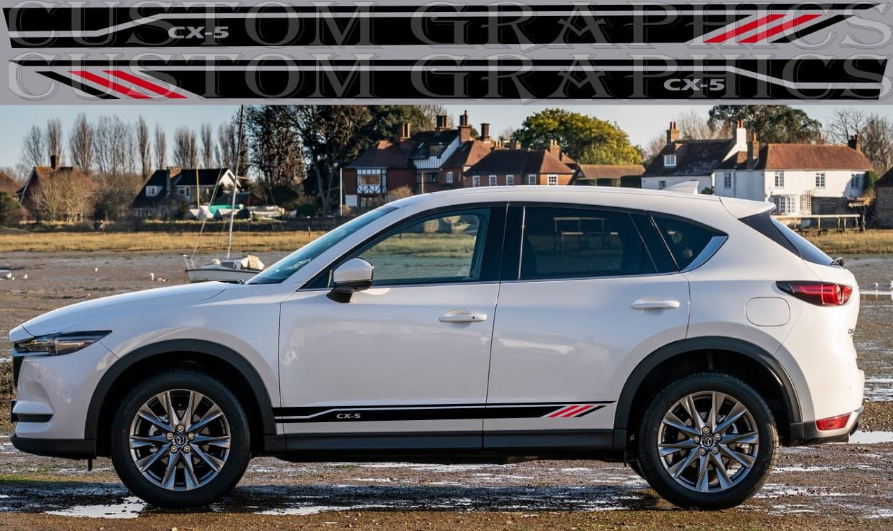 A white Mazda CX-5 SUV with vinyl stripes and decals on its body, displayed against a roadside background.